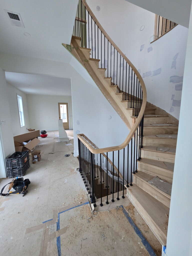Finished indoor staircase with oak handrail and balustrades