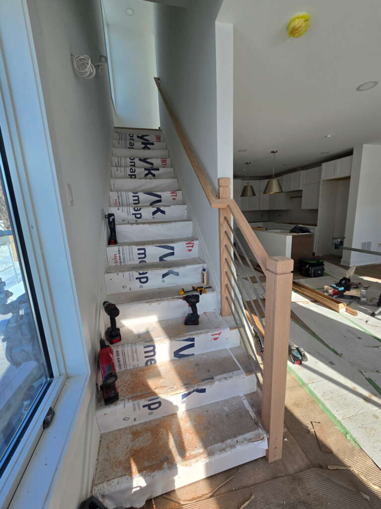 Granite stair treads paired with modern iron panels